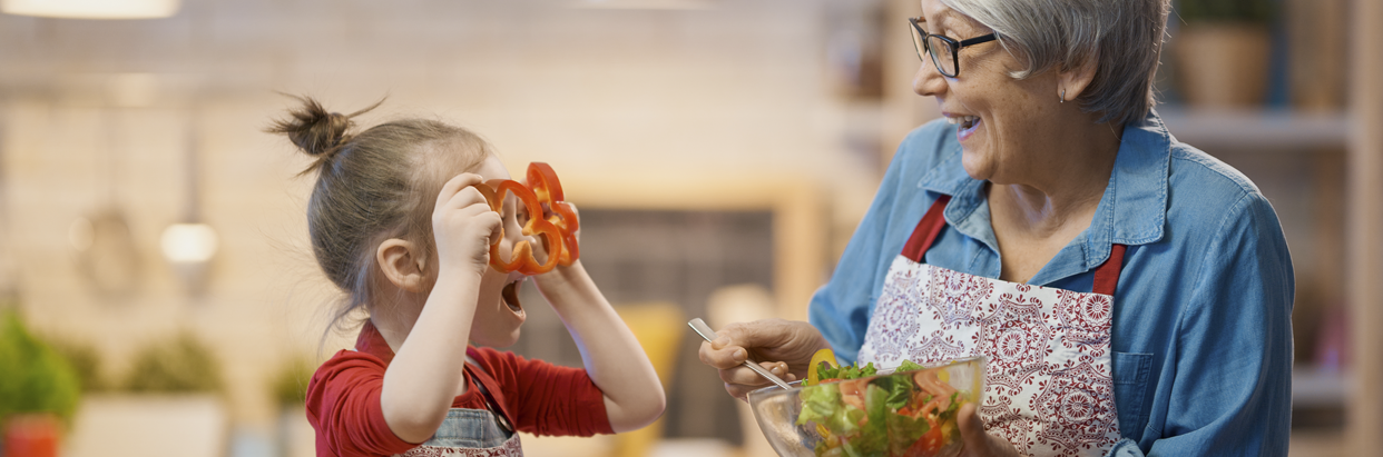 girl-and-grandma-prepping-peppers-in-kitchen-1242x411.png