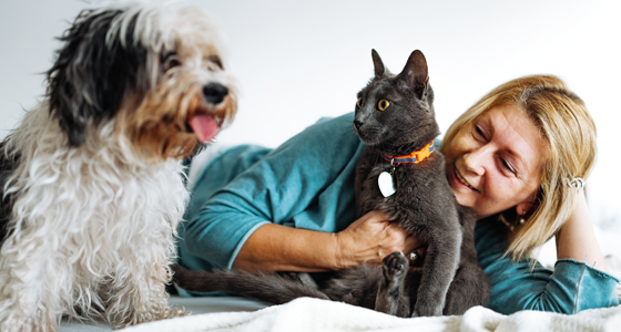 woman-with-cat-and-dog-560x300.png