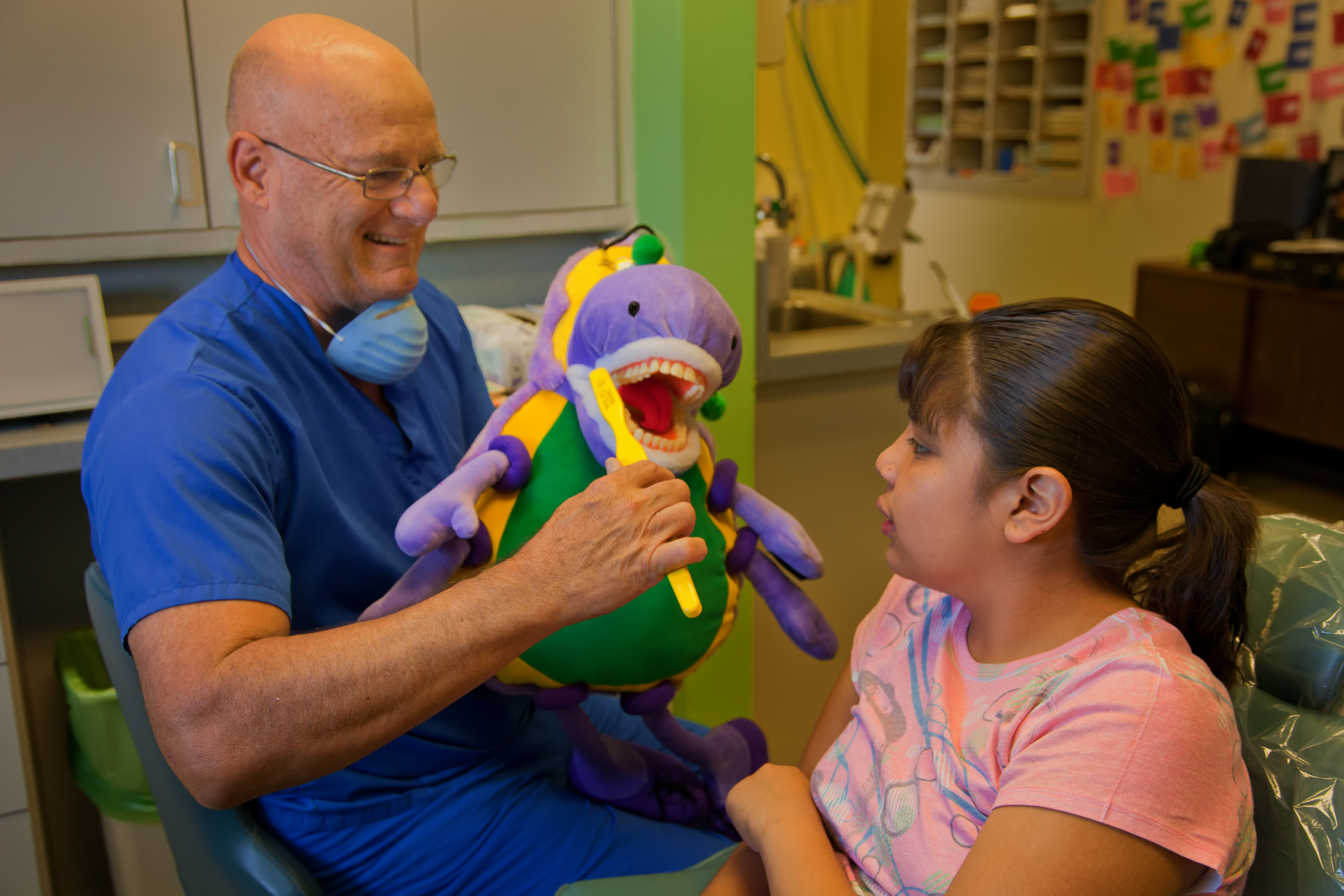 St. Vincent de Paul dental director teaches child about brushing 