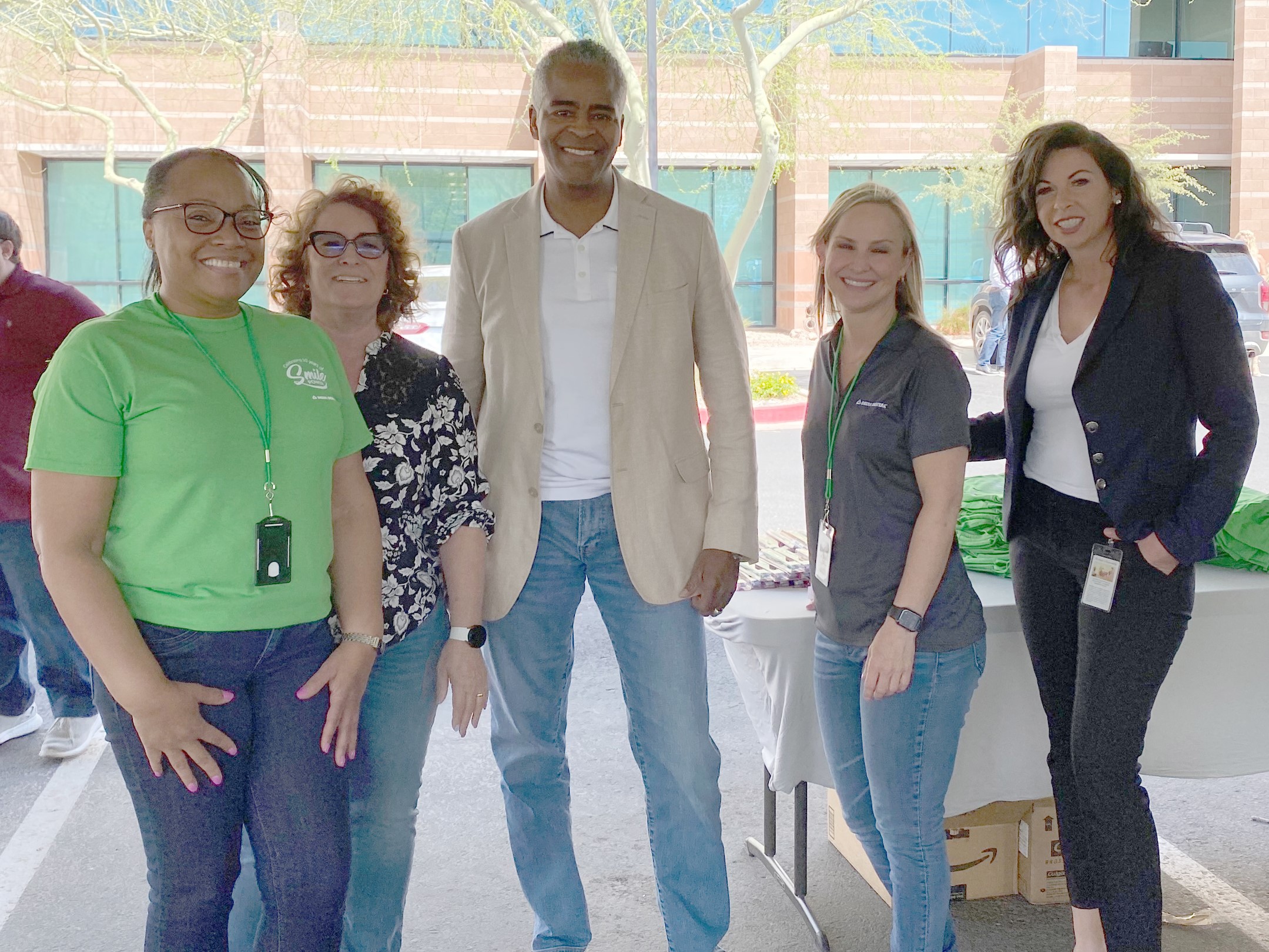 Diverse team members smiling in the Delta Dental parking lot