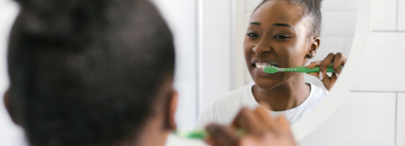 girl-brushing-teeth-in-mirror-1600x578.jpg