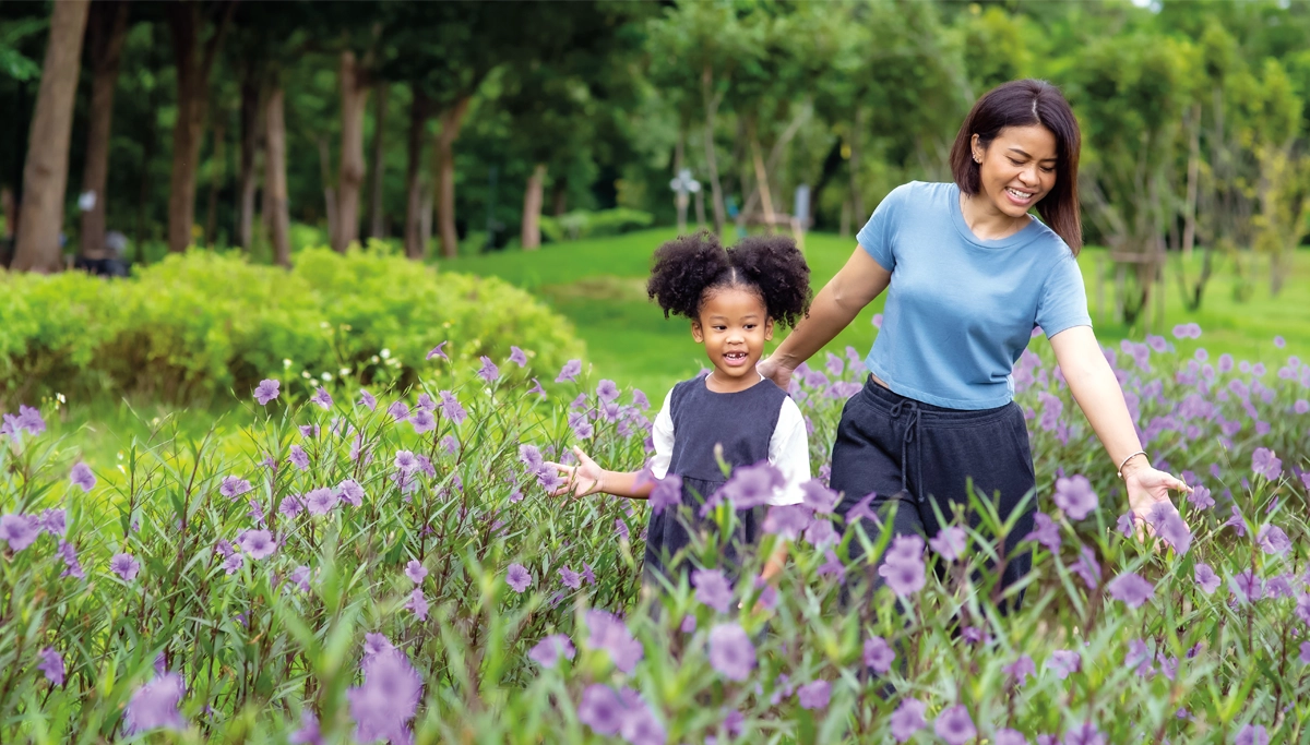 mom-and-daughter-walking-through-flowers-1200x683.webp