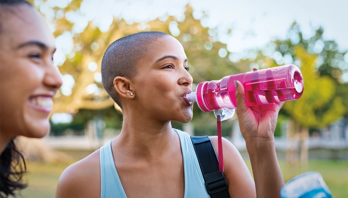 woman-drinking-from-pink-water-bottle-1200x683.webp