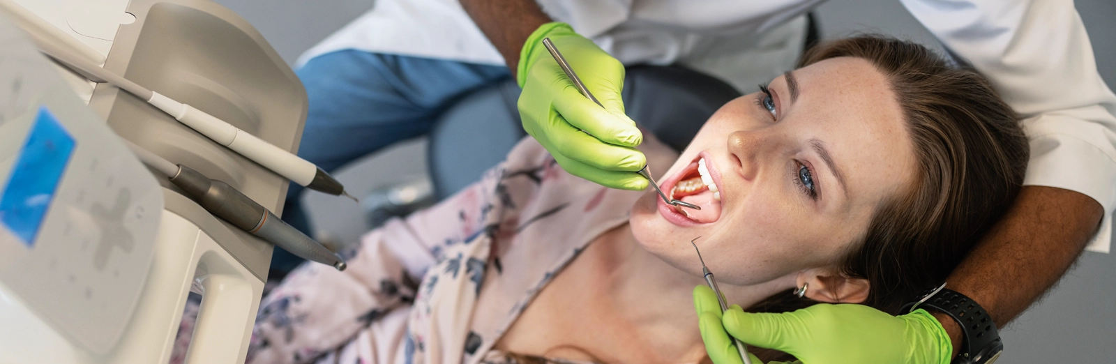 woman-getting-her-teeth-cleaned-1600x522.webp